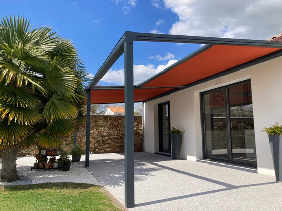 pergola toile sur mesure dickson adossée à une maison moderne dans jardin ensoleillé